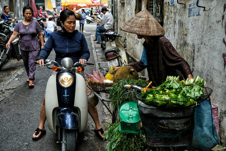 Hanoi, Vietnam - August 31: Vendors selling fruit and vegetables in the street in the old quarter on August 31, 2018 in Hanoi, Vietnam.のeditorial素材
