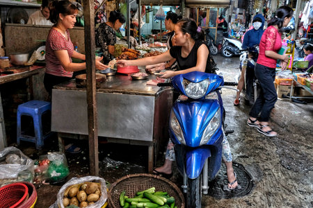 Hanoi, Vietnam - August 31: Vendors selling fruit and vegetables in the street in the old quarter on August 31, 2018 in Hanoi, Vietnam.のeditorial素材