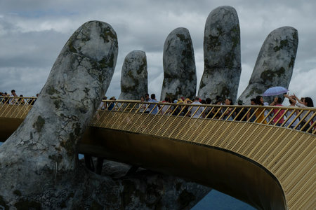 Da Nang, Vietnam - August 18, 2018: Tourists in the Golden Bridge. The Golden Bridge is 150 m long pedestrian bridge in the Ba Na Hills in Da Nang.のeditorial素材