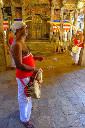 Kandy, Sri Lanka - January 2020: A man plays the drum during the offering at the Temple of the Tooth of Buddha on January 26, 2020 in Kandy, Sri Lanka.のeditorial素材