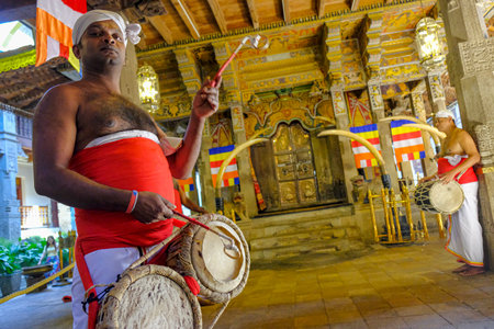 Kandy, Sri Lanka - January 2020: A man plays the drum during the offering at the Temple of the Tooth of Buddha on January 26, 2020 in Kandy, Sri Lanka.のeditorial素材