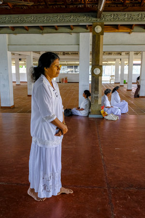 Kalutara, Sri Lanka - January 2020: Women praying at the Kalutara Bodhiya was previously know as Gangathilaka Viharaya on January 30, 2020 in Kalutara, Sri Lanka.のeditorial素材