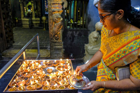 Colombo, Sri Lanka - February 2020: Woman making offering in the Sri Siva Subramania Swami Kovil...
