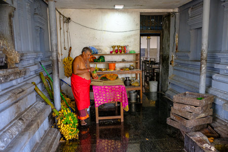 Colombo, Sri Lanka - February 2020: A monk preparing an offering in the New Kathiresan Kovil Temple on February 4, 2020 in Colombo, Sri Lanka.のeditorial素材