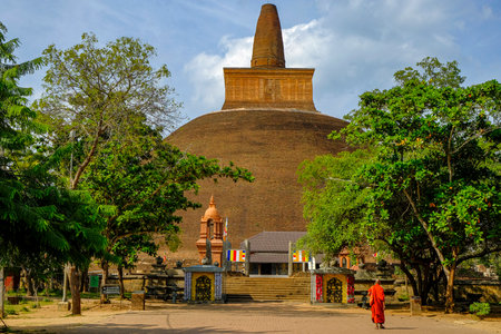 Anuradhapura, Sri Lanka - February 2020:  A monk visiting the Buddhist stupa Abhayagiri Dagoba on February 6, 2020 in Anuradhapura, Sri Lanka.のeditorial素材