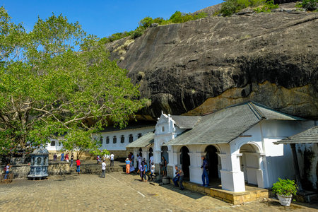 Dambulla, Sri Lanka - February 2020: People visiting Dambulla cave temple on February 8, 2020 in Dambulla, Sri Lanka. Cave V Devana Alut Viharaya. Major attractions are spread over 5 caves, which contain statues and paintings.のeditorial素材