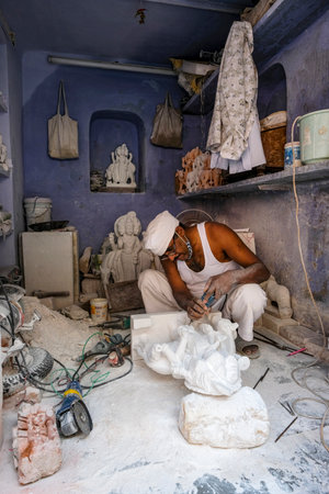 Jaipur, India - August 2020: A craftsman working on a marble statue in the old city of Jaipur on August 27, 2020 in Rajasthan, India.のeditorial素材