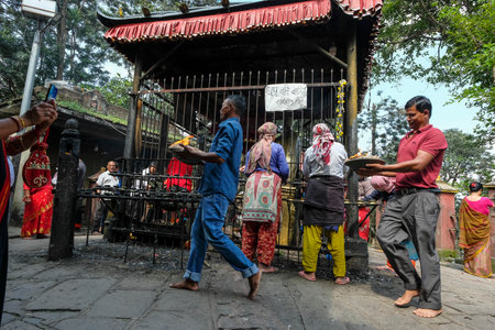 Bhaktapur, Nepal - October 2021: People making an offering at the Mahakali Temple in Bhaktapur on October 9, 2021 in Kathmandu Valley, Nepal.のeditorial素材