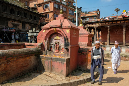 Bhaktapur, Nepal - October 2021: Two men walking down the street in Bhaktapur on October 9, 2021 in Kathmandu Valley, Nepal.のeditorial素材