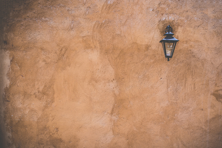 Concrete wall texture in light brown with red and street lampの写真素材