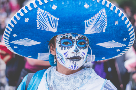 Woman disguised as charra in blue with catrina make-up.のeditorial素材