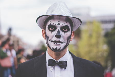 Foreign man in Mexico City with skeleton make-up and gala dress.のeditorial素材