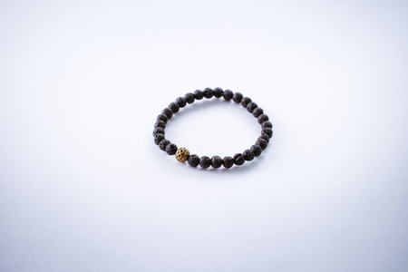 Bracelet made of volcanic stone with gold detail.の写真素材
