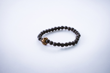 Bracelet made of volcanic stone with gold detail.の写真素材