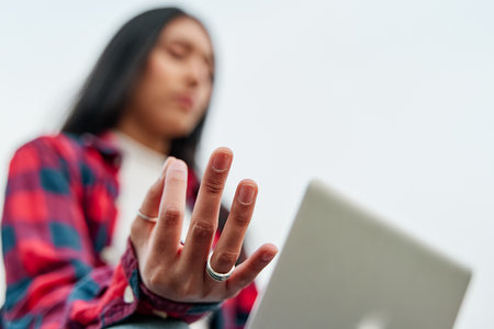 Close-up of a woman with laptop computer and more meditating hands. Selective focusの写真素材