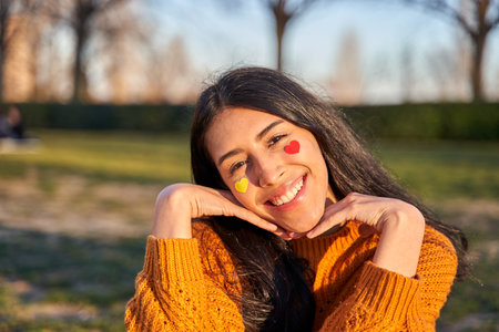 woman with hearts in her cheeks and a gesture of love and happiness.の写真素材