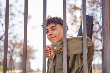 Latin smiling man behind fenceの写真素材