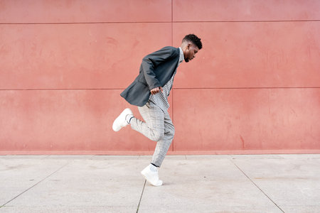 african-american man dancing outdoors in casual clothesの写真素材