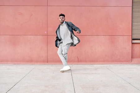 african-american man dancing outdoors in casual clothesの写真素材