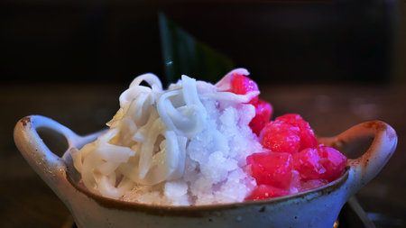 Close up, selective focus, Red Rubies Dessert or Tub Tim Krob, Thapthim krop, famous Thai sweet local menu, shave ice crispy ruby with coconut in coconut milk, delicious tastyの写真素材