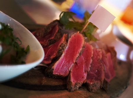 Close up Sliced grilled rare beef steak served on wooden board, Barbecue, bbq meat beef tenderloin, copy space on blank flag, food wallpaperの写真素材