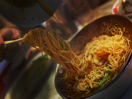 Enjoy second dish of stir fried egg noodle chinese menu in night market Street food Bangkok with friends, one is not enoughの写真素材