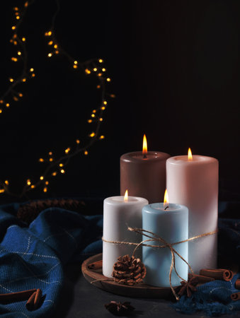 Candles for cold weather. Christmas celebration or cold winter evening conceptの写真素材