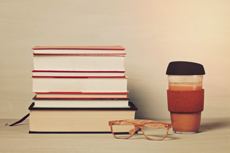 Books, cup of coffee, reading glasses. Education, study, reading, leisure conceptの写真素材