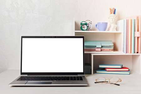 Empty laptop screen, desktop organizer with desk shelves and office supplies. Back to school, home office, begining of studies concept. Mockup, templateの写真素材