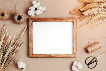Bouquets of dry flowers and herbs and wooden frame mockup, trendy interior decoration, artisan florist shop idea. Top view, flat lay, copy spaceの写真素材