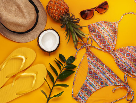 Summer vacation, travel, tourism concept flat lay. Tropical beach accessories top view with swimming suit, hat and flip flopsの写真素材