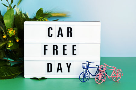 Toy bicycle and lightbox with text car free day. World bicycle day, environment protection, sustainable lifestyle concept with copy spaceの写真素材