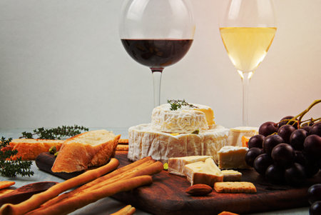 French cheese plate and a glass of wine for buffet party. Traditional french or italian entiresの写真素材