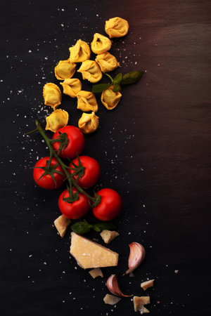 Italian pasta with cheese, basil and tomatoes. Fresh organic food conceptの写真素材