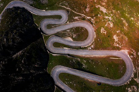 A green pass road from above