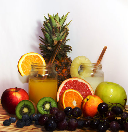 Juices smoothies and fresh pineapple and orange drinks with summer fruitsの写真素材