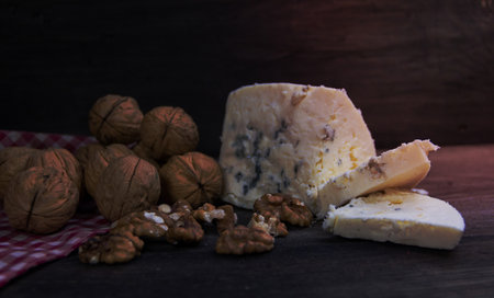 roquefort cheese with walnuts on dark backgroundの写真素材