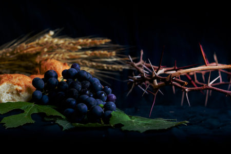 wheat grapes bread and crown of thorns on black background as a symbol of Christianityの写真素材