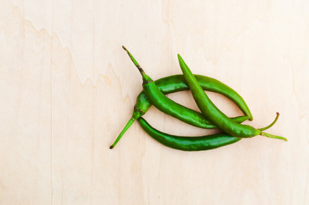 fresh green hot chilli peppers with spicy on the woodenの写真素材