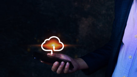 Businessman holding smartphone with virtual cloud computing to transfer database information upload, download application. technology business transformation concept.の写真素材
