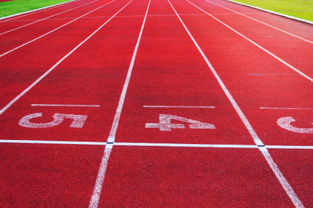 Numbers starting point on red running track,running track and green grass,Direct athletics Running...