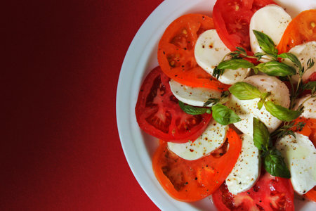 On a white plate, a tomato salad is garnished with mozzarella .Texture or background