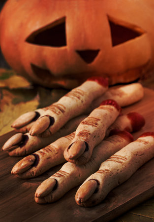 Halloween finger cookies and pumpkinの写真素材