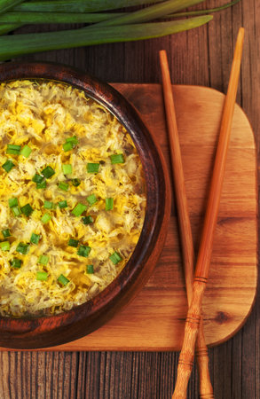 Hot vegetarian egg drop soup with starch noodlein wooden bowl on vintage backgroundの写真素材
