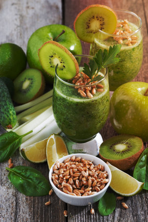 healthy green smoothie with sprouts on a wooden table, vertical, top viewの写真素材
