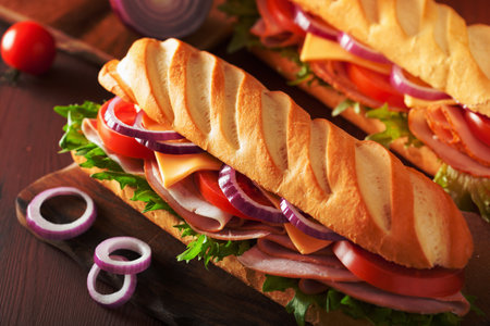 long baguette sandwich with ham cheese tomato lettuceの写真素材