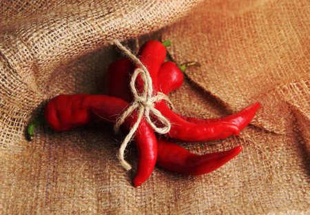 Red hot chili peppers on sackcloth, backgroundの写真素材