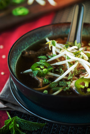 Vietnamese beef Pho soup with jalapeno mint and bean sprouts
