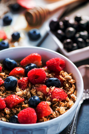 Bowl with fresh berries and cereal for breakfastの写真素材