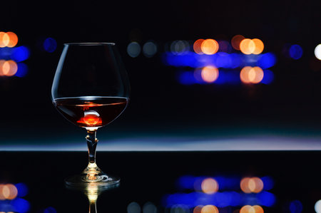 snifter with brandy on  dark backgroundの写真素材